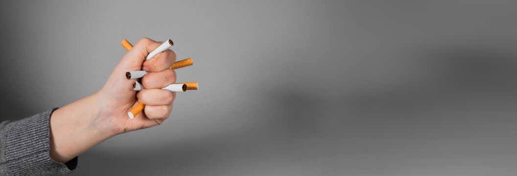 Conceptual image of quitting smoking by crushing a cigarette in a clenched fist, symbolizing strength, determination, breaking addiction, and commitment to a smoke-free lifestyle.