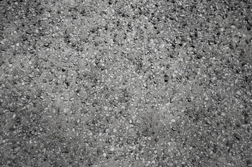 Fototapeta premium Gray background, photo shows the texture of a gray concrete wall with small stone inclusions