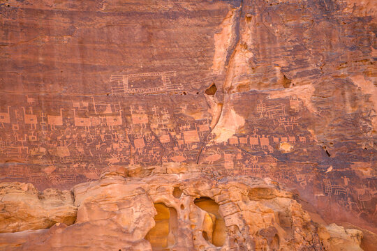 Wadi Alna'am, AlUla, Saudi Arabia - Jan 8, 2025: Ancient petroglyphs showing ostriches, other animals, and human figures etched on desert rock walls in Wadi Alna'am, AlUla, Saudi Arabia