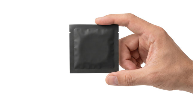 Hand holding black condom sachet isolated on transparent background png