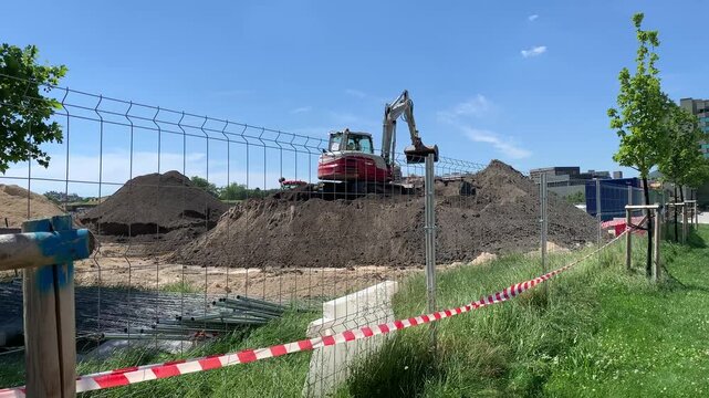 Pamplona, ​​Navarra, Spain;  Mastering the Terrain: Aerial Maneuvers with a Mini Excavator