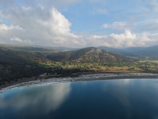 Fototapeta premium aerial view coastli. sunbeams from behind the clouds over the lakes. view from a drone of a lake in the mountains. High quality 4k footage