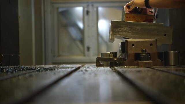 Technicians are installing a grinding machine to grind and shape automotive parts in an automotive parts manufacturing plant