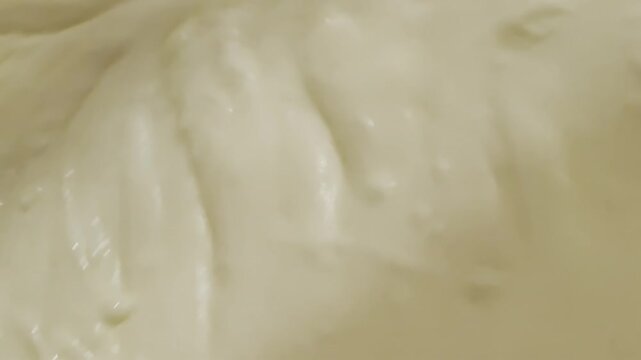 Whiskiing thick vanilla cream at home, making a homemade cake on a weekend,
