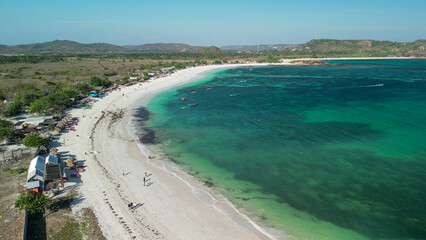 Fototapeta premium Aerial drone view Tanjung Aan Beach Lombok Indonesia featuring white sand turquoise bay hills and tropical coastal paradise