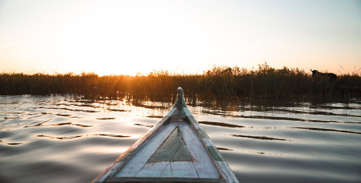 Exploring the serene waters of Mesopotamian Marshes in Iraq during sunset