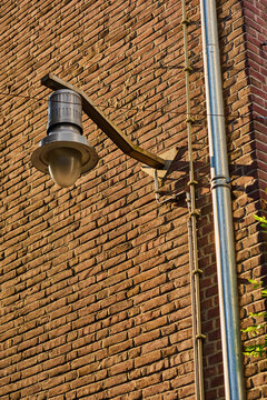 Warm Light Illuminating a Brick Wall in the Heart of Amsterdam's Charming City Center During a Sunny Afternoon