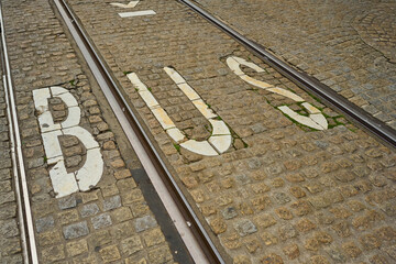 Fototapeta premium Cobblestone Streets in Amsterdam Reveal the Bustling Atmosphere of the City Center Highlighting Traffic and Transit