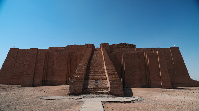 Visiting the ancient ziggurat of Ur in Iraq under a clear blue sky during midday