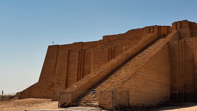 Exploring the ancient ziggurat of Ur in Iraq during a clear blue sky