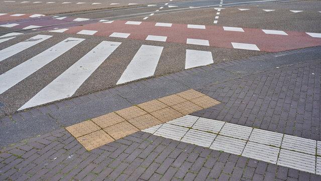 Stepping Across Colorful Crosswalks in the Vibrant Streets of Amsterdam's City Center During a Sunny Day