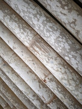 Close up view background from old bambo fence with snow