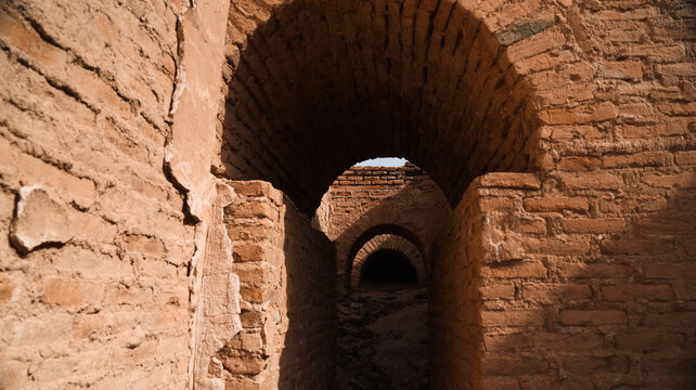 Exploring ancient brick arches in Iraq archaeological site at sunset