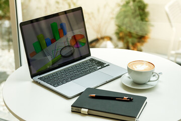 Fototapeta premium Creative brainstorming session at a cafe with coffee, stationery, and computer on the desk.