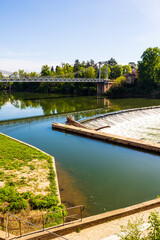 Fototapeta premium Suspension bridge crossing the Tarn river linking the historic center of Villemur-sur-Tarn to the rest of the municipality