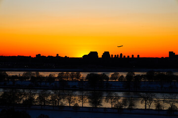 Fototapeta premium Jetliner Plane Takes off at Sun Set Golden Hour, DC