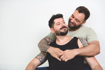Obraz premium Young homosexuals gay couple love each other on a white background.