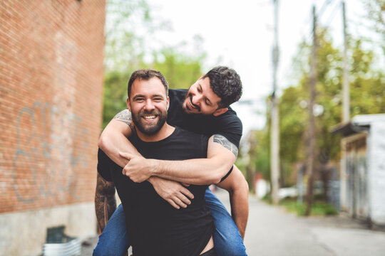 A Portrait of a happy gay couple outdoors in urban background