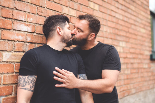 A Portrait of a happy gay couple outdoors in urban background
