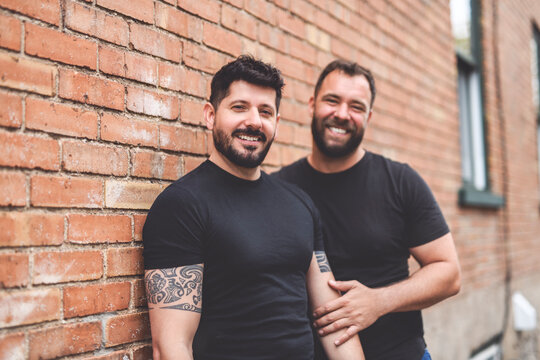 A Portrait of a happy gay couple outdoors in urban background
