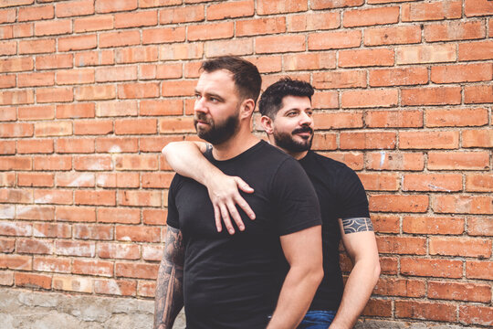A Portrait of a happy gay couple outdoors in urban background