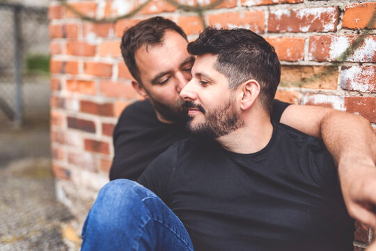 A Portrait of a happy gay couple outdoors in urban background