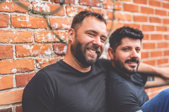 A Portrait of a happy gay couple outdoors in urban background