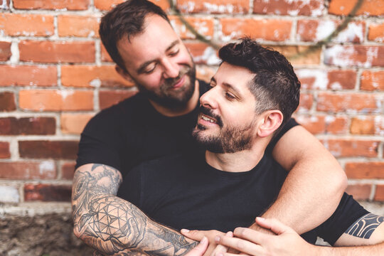 A Portrait of a happy gay couple outdoors in urban background
