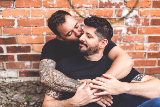 A Portrait of a happy gay couple outdoors in urban background