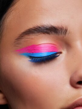 Makeup tutorial featuring bright colors on the eyes in a close-up shot