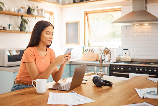 Woman, happy and finance in home with phone, pay slip update and online banking at laptop. Person, mobile and tech in kitchen for account management, debt payment and smile for easy transaction