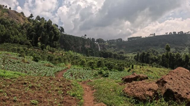 Epic waterfall landscape at Sipi Falls Uganda with flowing water and vibrant green surroundings, cinematic nature footage