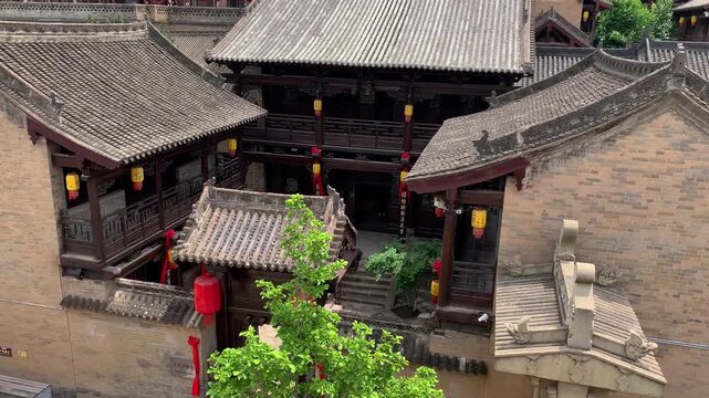 Traditional Chinese Courtyard with Tiled Roofs and Red Lanterns