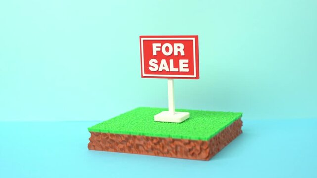 A plot of land is for sale. The plot area has a green lawn and a For Sale sign. Real estate opportunities support investment, development and property ownership.