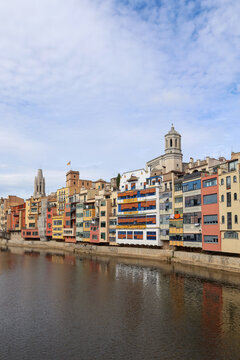 Scenic View of Colorful Houses Along the Onyar River with the Historic Cathedral in Girona Spain