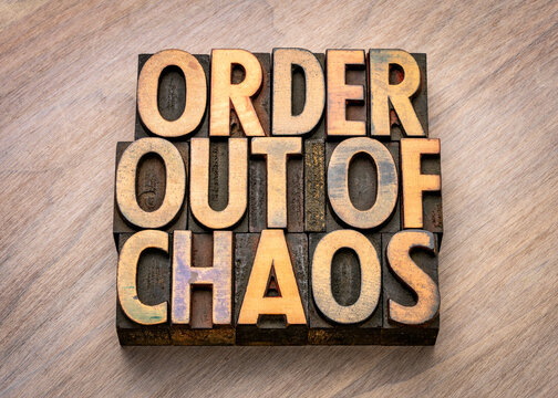 order out of chaos - words in vintage wooden letterpress printing blocks, stained by color inks