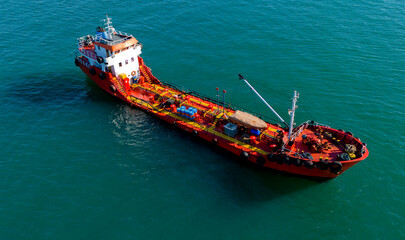 Drone shot of a red chemical tanker ship navigating beautifully across the ocean © Buğra Kaan Ersoy