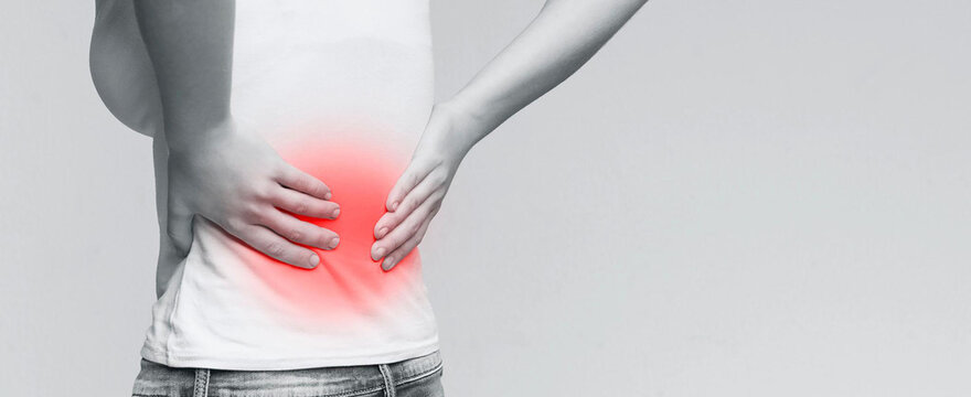 Conceptual medical photo of office syndrome showing painful lumbar vertebrae L4-L5.