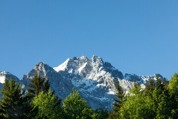 Obraz premium Travel landscape of Zugspitze Alps in Bavaria Germany, scenic summer nature panorama with forest, snow mountains peak