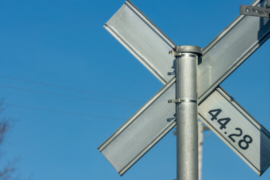 MONTREAL, CANADA, 26 December 2025 : railway crossing sign with blue sky