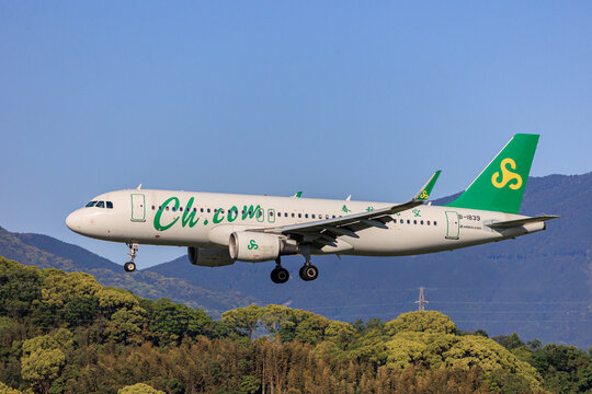 Fukuoka, Japan - May 26, 2026: An aerial view of the densely populated Fukuoka cityscape and buildings from a window seat of a Spring Airlines Airbus A320 just after takeoff.