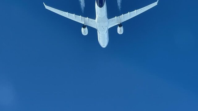 A spectacular pilot point of view of an airliner passing from above.