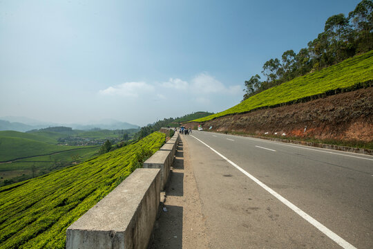 A breathtaking panoramic view of Munnar's unique topography, characterized by an endlessly rolling terrain of deep green valleys.