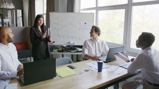 Diverse team discusses financial strategies in a meeting room during a collaboration session