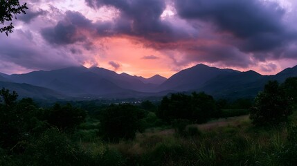 Obraz premium A dramatic and colorful sky with vibrant clouds over a vast landscape during sunset or sunrise