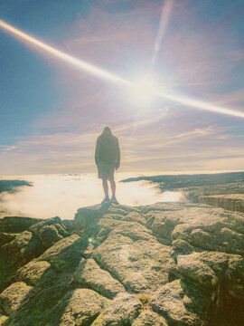 man in the mountain above clouds