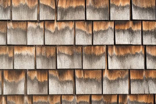 Close-up view of gray weathered shingles on typical Cape Cod building.