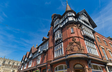A charming historic red brick and timber-framed building with a turret against a clear blue sky in Gloucester - Gloucestershire - UK © Robert
