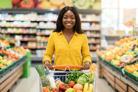 happy african woman shopping in a grocery store, demonstrating informed consumer. Brazilian woman.