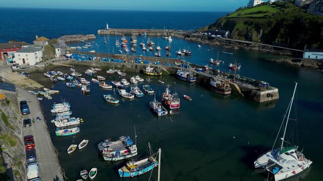 Aerial views of the harbor in the costal village and port of Mevagissey on the south coast of Cornwall in the southwest of England.